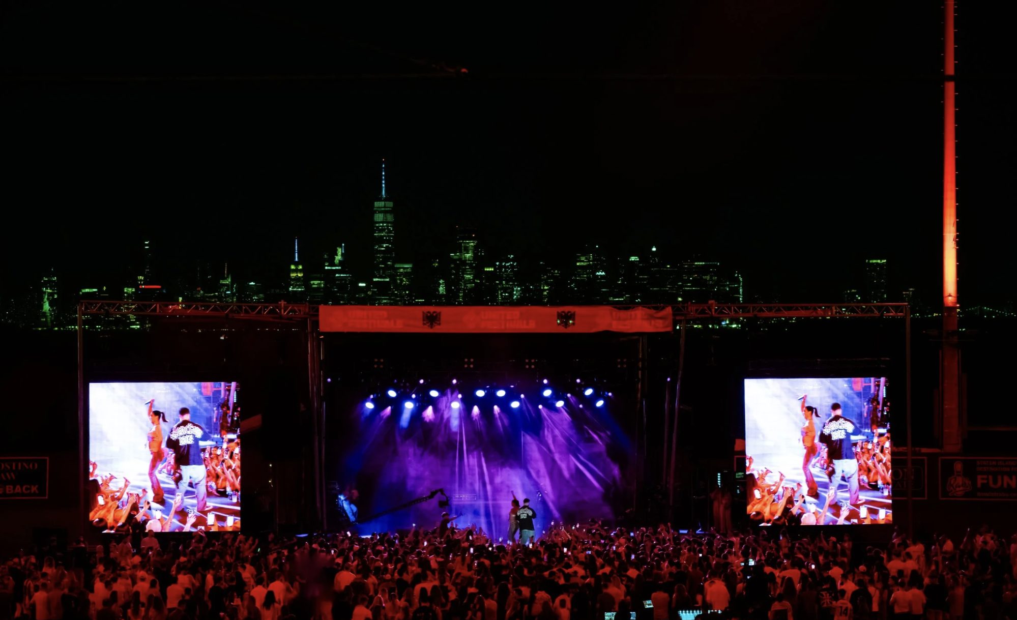 United FestivALB main stage lit at night against the skyline